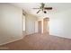Bedroom featuring neutral paint, carpet flooring, ceiling fan, and access to other areas of the home at 18003 W Carmen Dr, Surprise, AZ 85388
