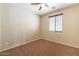 Comfortable bedroom with a cozy ceiling fan and a sunlit window at 18003 W Carmen Dr, Surprise, AZ 85388