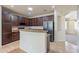 Bright kitchen features granite countertops, modern appliances, a breakfast bar, and ample cabinet space at 18003 W Carmen Dr, Surprise, AZ 85388