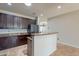 Open kitchen with breakfast bar, stainless steel appliances, granite countertops, and ample storage at 18003 W Carmen Dr, Surprise, AZ 85388