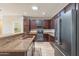 Well-equipped kitchen featuring granite counters, stainless appliances, rich wood cabinets, and tile flooring at 18003 W Carmen Dr, Surprise, AZ 85388