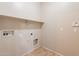 Laundry room featuring utility hook-ups and shelving, designed for efficient laundry tasks at 18003 W Carmen Dr, Surprise, AZ 85388