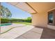 Covered patio area overlooks a pool, artificial grass, and a fire pit, perfect for outdoor enjoyment at 18003 W Carmen Dr, Surprise, AZ 85388