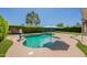 Backyard featuring a swimming pool, patio, and mature landscaping at 18003 W Carmen Dr, Surprise, AZ 85388