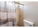 Tile shower and decorative shower curtain in bathroom at 18003 W Carmen Dr, Surprise, AZ 85388