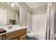 Cozy bathroom featuring a shower-tub combo and a wooden vanity at 18016 N 145Th Ave, Surprise, AZ 85374
