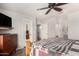 Bedroom featuring wood floors and a dresser with a television on top at 18016 N 145Th Ave, Surprise, AZ 85374