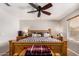 Cozy bedroom with ceiling fan, dresser, and natural light at 18016 N 145Th Ave, Surprise, AZ 85374