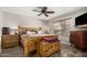 Spacious bedroom featuring a ceiling fan, dresser, and large windows offering plenty of natural light at 18016 N 145Th Ave, Surprise, AZ 85374