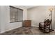 Bedroom showcasing a rocking chair, area rug, floor lamp, and wooden dresser against neutral walls at 18016 N 145Th Ave, Surprise, AZ 85374