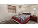 Bedroom with colorful bedspread, side table and lamp at 18016 N 145Th Ave, Surprise, AZ 85374
