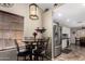Cozy dining area with a stainless steel refrigerator and modern lighting fixture at 18016 N 145Th Ave, Surprise, AZ 85374
