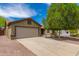 Charming single-story home with a well-manicured lawn and a two-car garage at 18016 N 145Th Ave, Surprise, AZ 85374