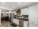 Bright kitchen with stainless steel appliances, white cabinets, and granite countertops at 18016 N 145Th Ave, Surprise, AZ 85374