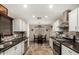 Well-lit kitchen featuring updated appliances, granite countertops, and a dining table for casual meals at 18016 N 145Th Ave, Surprise, AZ 85374