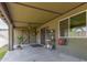 Covered patio with ceiling fan, storage, and access to backyard and featuring neutral color scheme at 18016 N 145Th Ave, Surprise, AZ 85374