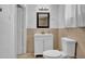 A well lit bathroom features a clean white vanity, large mirror and coordinating neutral tile at 1815 E Illini St, Phoenix, AZ 85040