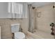 A clean bathroom features a shower with tiled walls, a patterned floor, and neutral accents at 1815 E Illini St, Phoenix, AZ 85040