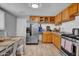 Well-lit kitchen featuring stainless steel appliances, wooden cabinets, and a practical layout at 1815 E Illini St, Phoenix, AZ 85040