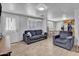 Cozy living room featuring a plush sofa, modern lighting, and easy access to dining at 1815 E Illini St, Phoenix, AZ 85040