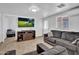 Cozy living room with a comfortable gray sofa, entertainment center, and bright natural light at 1815 E Illini St, Phoenix, AZ 85040