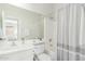 Clean bathroom showcases a shower with curtain and a sink with vanity at 18414 W La Mirada Dr, Goodyear, AZ 85338