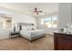 Bright Primary bedroom with ceiling fan and large windows allowing natural light at 18414 W La Mirada Dr, Goodyear, AZ 85338