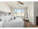 Comfortable Primary bedroom with large window views of the outdoors and neutral-colored decor at 18414 W La Mirada Dr, Goodyear, AZ 85338