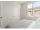 Bedroom featuring a light-filled window, closet with sliding doors, and a comfortable bed at 18414 W La Mirada Dr, Goodyear, AZ 85338