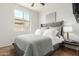 Bedroom features a gray bed frame, a window, a side table with a lamp and carpeted floors at 18414 W La Mirada Dr, Goodyear, AZ 85338