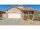 Charming single-story home with a well-maintained front yard and a two-car garage at 18414 W La Mirada Dr, Goodyear, AZ 85338