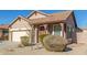 Charming single-story home featuring desert landscaping, a two car garage, and a welcoming covered porch at 18414 W La Mirada Dr, Goodyear, AZ 85338