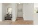 Bright hallway with tiled floors, leading to additional rooms and featuring a decorative bench at 18414 W La Mirada Dr, Goodyear, AZ 85338