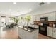 Eat-in kitchen with island features granite countertops, stainless steel appliances, and open access to the dining area at 18414 W La Mirada Dr, Goodyear, AZ 85338