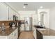 Bright kitchen with granite countertops, stainless steel appliances and tile floors at 18414 W La Mirada Dr, Goodyear, AZ 85338