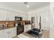 Modern kitchen features stainless steel appliances, granite countertops, and ample cabinet space at 18414 W La Mirada Dr, Goodyear, AZ 85338