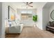 Bright living room with neutral walls, carpet, ceiling fan and natural light at 18414 W La Mirada Dr, Goodyear, AZ 85338