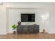 Contemporary living room featuring a dark wood console table and a large mounted TV at 18414 W La Mirada Dr, Goodyear, AZ 85338