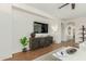 Elegant living room featuring a stylish console table, modern lighting, and tile flooring at 18414 W La Mirada Dr, Goodyear, AZ 85338