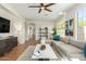 Well-lit living room with a cozy sectional sofa, modern decor, and tiled flooring at 18414 W La Mirada Dr, Goodyear, AZ 85338