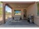 Cozy covered patio includes seating, a grill, and an inviting outdoor space at 18414 W La Mirada Dr, Goodyear, AZ 85338