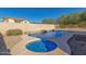 Stunning backyard pool and spa with rock waterfall feature, surrounded by desert landscaping at 18414 W La Mirada Dr, Goodyear, AZ 85338