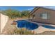Private backyard featuring a sparkling pool, spa, covered patio, and desert views at 18414 W La Mirada Dr, Goodyear, AZ 85338
