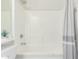 Bright bathroom with a shower/tub combination and a decorative plant on the toilet at 18414 W La Mirada Dr, Goodyear, AZ 85338