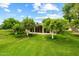 Manicured backyard with lush lawn and mature trees, offering privacy at 19053 N Lakeforest Dr, Sun City, AZ 85373