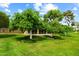 Expansive backyard view, showcasing the well-maintained lawn and beautiful trees at 19053 N Lakeforest Dr, Sun City, AZ 85373
