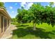 Mature trees surround the manicured lawn, enhancing the backyard's beauty at 19053 N Lakeforest Dr, Sun City, AZ 85373