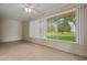 Bedroom with a large window letting in natural light and views of the outside at 19053 N Lakeforest Dr, Sun City, AZ 85373