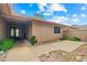Covered front entrance with double doors, low-maintenance landscaping and a concrete walkway at 19053 N Lakeforest Dr, Sun City, AZ 85373