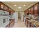 Spacious kitchen features granite countertops, ample cabinet space, and modern appliances, including a white refrigerator at 19053 N Lakeforest Dr, Sun City, AZ 85373